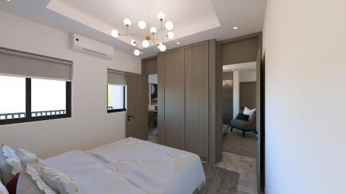 a bedroom with a bed and a chandelier at Aurelia Apartments in Mama