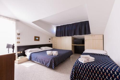 Postel nebo postele na pokoji v ubytování Villaggio Margherita