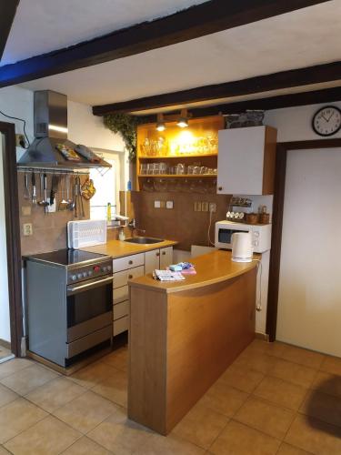 a kitchen with a stove and a counter top at Chata Radim 