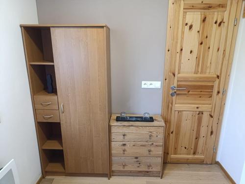 a closet with a dresser and a wooden door at Chata Radim 