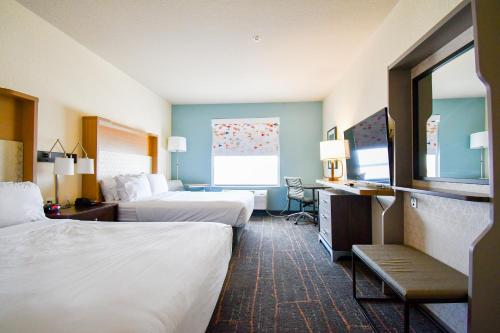 a hotel room with two beds and a desk at Holiday Inn San Antonio North Stone Oak Area by IHG-Newly Renovated in San Antonio