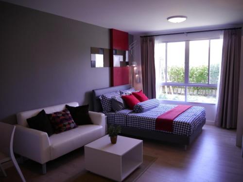 a living room with a bed and a couch at ฺBaan Peang Ploen Hua-Hin by Montri.C in Hua Hin