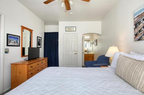 a bedroom with a bed and a tv on a dresser at Pacific Plaza #307 - Sand Dollar - 1BdrmUp-K in Oceano