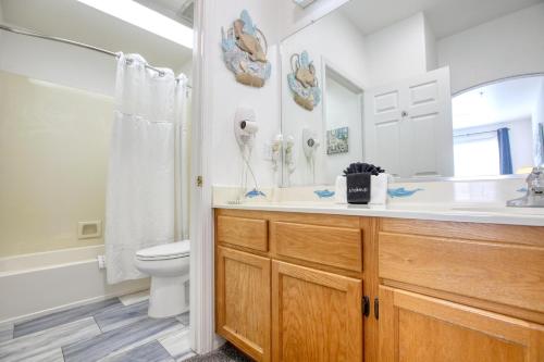 a bathroom with a sink and a toilet and a mirror at Pacific Plaza #307 - Sand Dollar - 1BdrmUp-K in Oceano