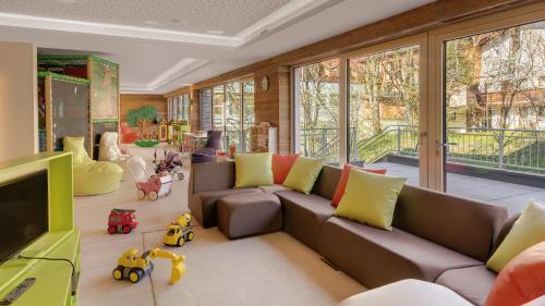 a living room with a couch and some toys at Wellnessresidenz Alpenrose in Maurach