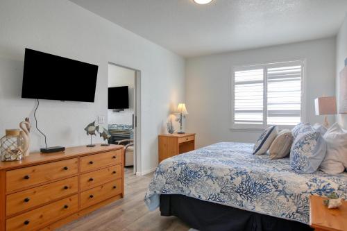 a bedroom with a bed and a dresser with a television at Pacific Plaza #409 - Peaceful Pearl - 1BdrmUp-K-QSofa in Oceano