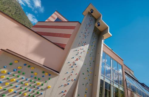 a gym with a climbing wall on the side of a building at Wellnessresidenz Alpenrose in Maurach