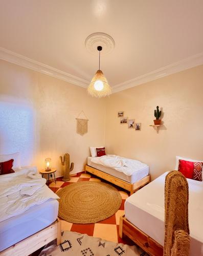 a room with two beds and a rug at Wild Surf Morocco in Agadir