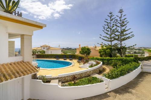 a villa with a swimming pool in a yard at Villa Sitambo- Pool & Sea View in Albufeira