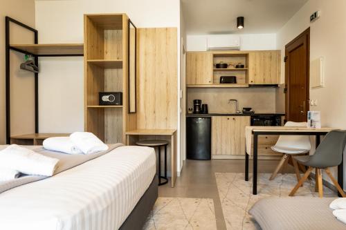 a hotel room with two beds and a kitchen at Helios Sivota in Sivota