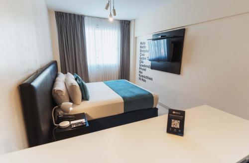a hotel room with a bed and a television at Cyan Recoleta Hotel in Buenos Aires