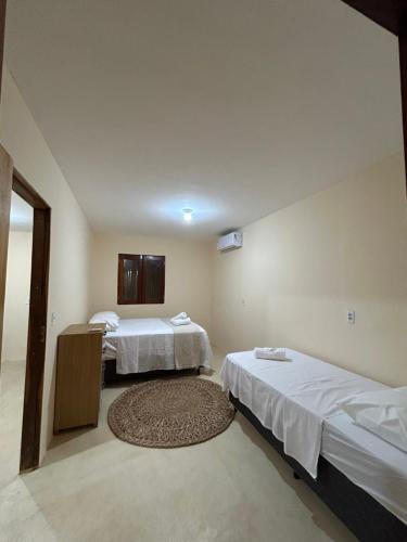 Postel nebo postele na pokoji v ubytování Villa Tijubina