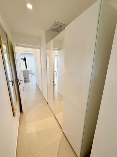 a hallway with white walls and a mirror on the wall at Garden Suite Vista Golf E-105 in Colorado