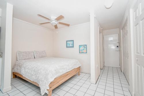 a bedroom with a bed and a ceiling fan at Park Place Unit 122 in Cedar Key