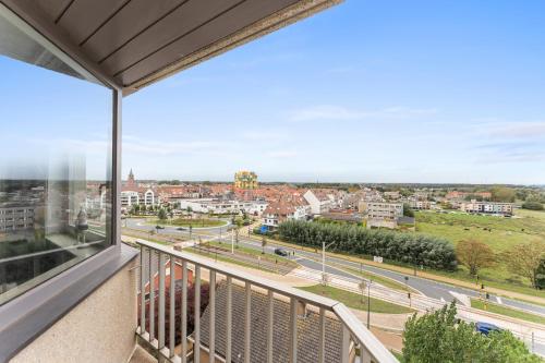 a balcony with a view of a city at Dunas Azules - cozy apartment with sea view in Mellet