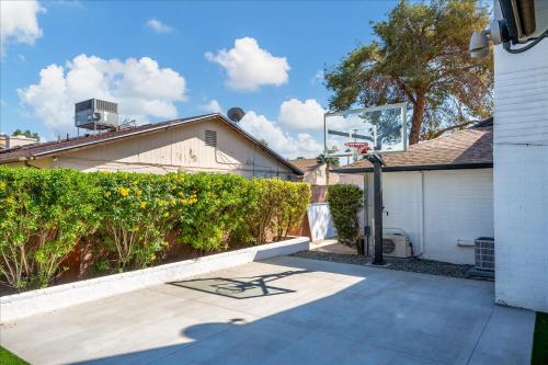 a patio with a bench in front of a house at Epic Mesa Getaway - Pool - Hot Tub - Game Room in Dobson Ranch