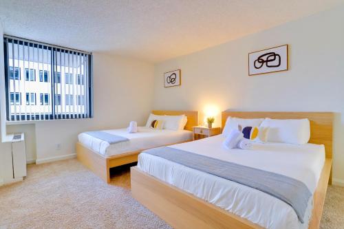 a bedroom with two beds and a window at A Few Steps From Airport - Stylish Apt in Addison Heights