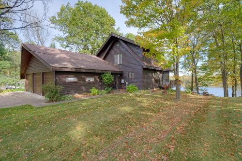 a house with a large yard in front of it at Rice Lake Cabin Retreat with Red Cedar Lake Access! in Rice Lake
