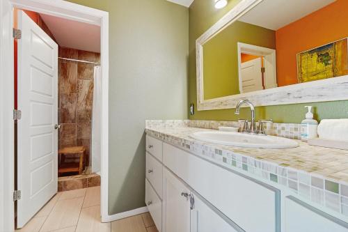 a bathroom with a sink and a mirror at Lost Colony #5 in Port Aransas