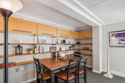 a dining room with a wooden table and chairs at Notchbrook 5 Apt. in Stowe