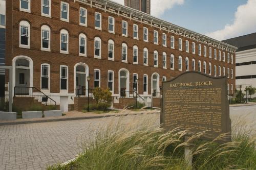 a brick building with a sign in front of it at Baltimore Place in Atlanta