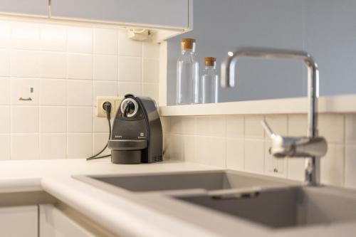 a kitchen sink with a hair dryer on the counter at Dunas Azules - cozy apartment with sea view in Mellet