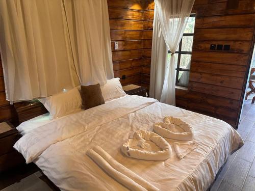 1 cama con 2 toallas grandes encima en كوخ الضباب للنزل الريفية, en Musaylah