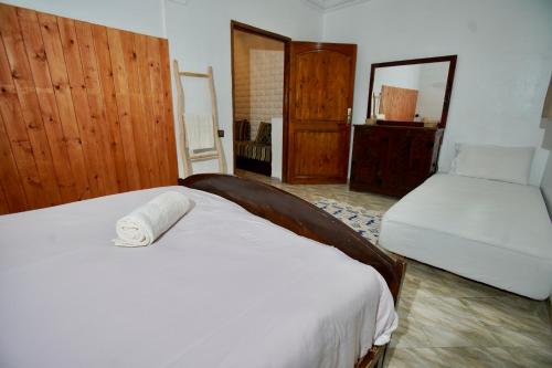 a bedroom with two beds and a mirror at Onda Surf in Taghazout