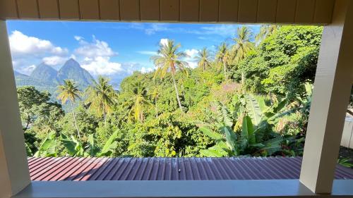 a view of a tropical forest from a window at Tranquil Villas in Soufrière