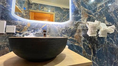 a bathroom with a bowl sink and a mirror at Tranquil Villas in Soufrière