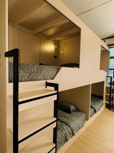 a room with a bunk bed in a room at Holy Hostel Sathorn in Thung Maha Mek