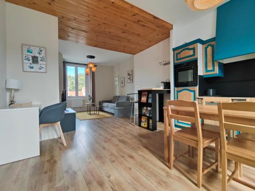 eine Küche und ein Wohnzimmer mit Tisch und Stühlen in der Unterkunft Cocon du Tisserand - Centre ville - Cosy et Intimiste in Cholet
