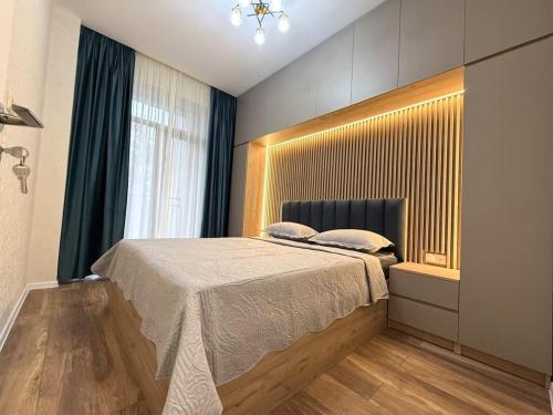 a bedroom with a large bed in a room at apartment in Tbilisi, Dighmis massive in Itʼkhvisi