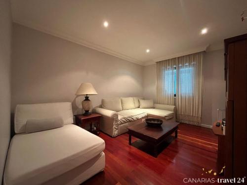 a living room with a bed and a couch at Versicolor in Los Llanos de Aridane