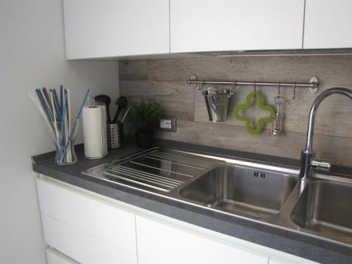 a kitchen with a stainless steel sink and a counter at Residence Villa Margherita in Brenzone sul Garda