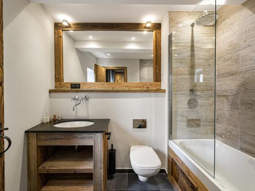 a bathroom with a sink and a toilet and a tub at Chalet savoyard 5 chambres avec sauna, navette gratuite et prestations haut de gamme, proche pistes - FR-1-570-8 in Saint-Martin-de-Belleville