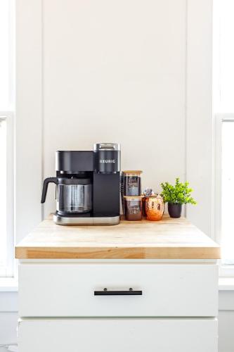 a coffee maker on a wooden counter in a kitchen at Short North Convention Private Parking Pets! in Columbus