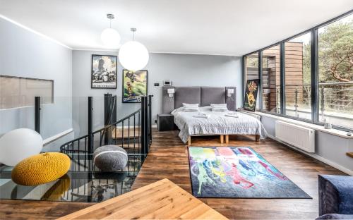 a living room with a table and some windows at Baltica Heaven by 2HomeRent - przestronne apartamenty premium przy samej plaży in Rogowo
