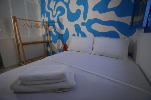 a bedroom with a bed with towels on it at Onda Surf in Taghazout