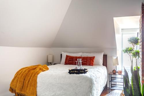 a bedroom with a large white bed with red pillows at Short North Convention Private Parking Pets! in Columbus