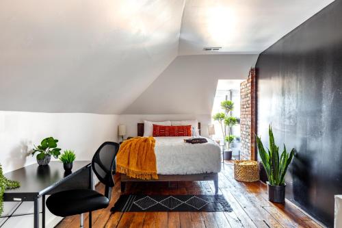 a bedroom with a bed and a desk at Short North Convention Private Parking Pets! in Columbus