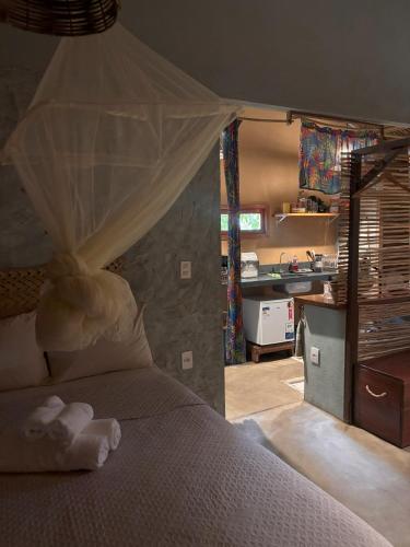 a bedroom with a bed with a mosquito net at Chalé Dona Ramira in Alter do Chao