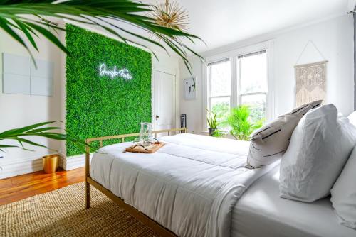 a bedroom with a white bed with a green wall at Short North Convention King Bed Free Parking! in Columbus