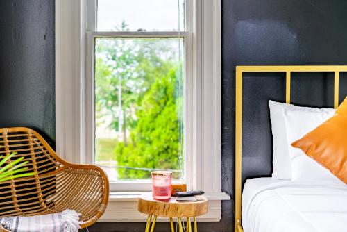 a bedroom with a bed and a window with a drink on a table at Short North Convention King Bed Free Parking! in Columbus