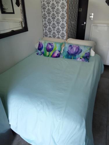 a white bed with two pillows on top of it at STUDIO Perpignan in Perpignan