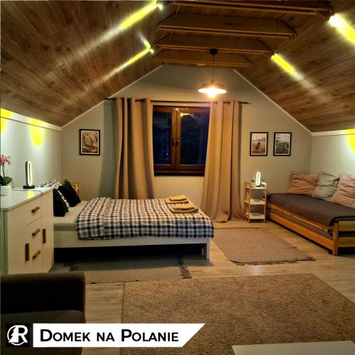 a bedroom with a bed and a couch at Ranczo w lesie - domki z jacuzzi in Ożarów