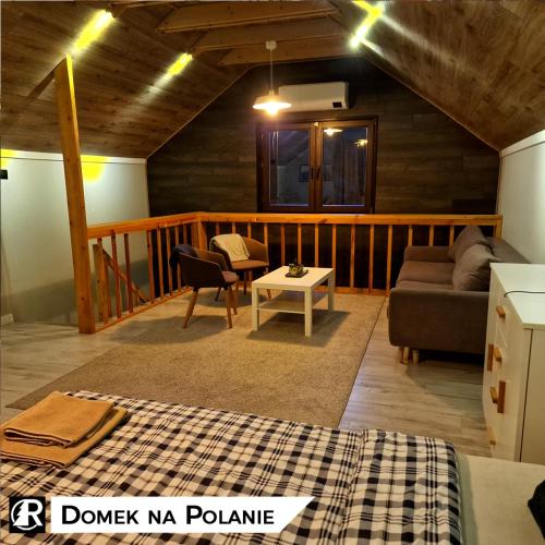 a living room with a couch and a table at Ranczo w lesie - domki z jacuzzi in Ożarów