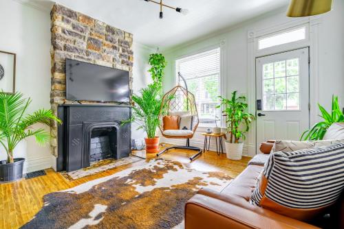a living room with a couch and a fireplace at Short North Convention King Bed Free Parking! in Columbus