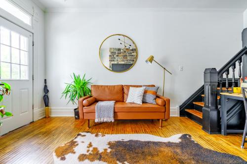 a living room with a couch and a mirror at Short North Convention King Bed Free Parking! in Columbus