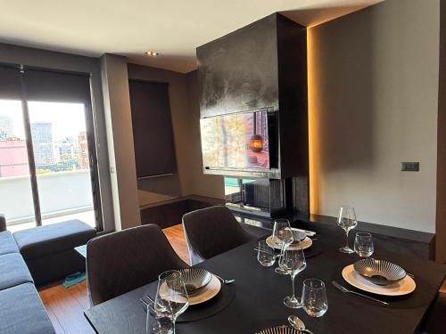 a dining room with a table with wine glasses at LA Luxury Rooftop in Tirana